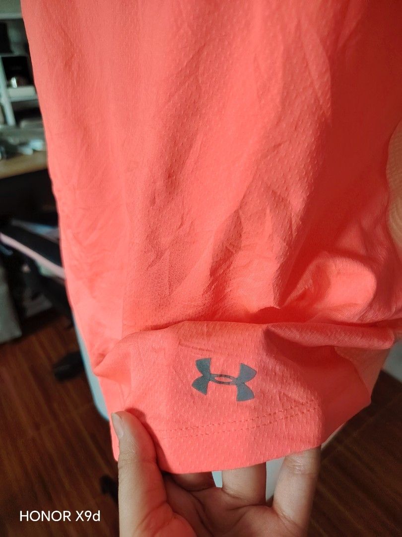Under Armour HeatGear Workout Tank Top (Category: Sleeveless) located in Mabalacat. Submitted by Jackikay.PreLoved (Listing ID 1469848558, Image 3). Description: Bright peach Under Armour athletic tank top. HeatGear mesh fabric keeps you cool during workouts. Racerback design with vertical Under Armour text on the back spine. Small UA logo on the lower hem. Size LG on the inner tag. Made in the Philippines..