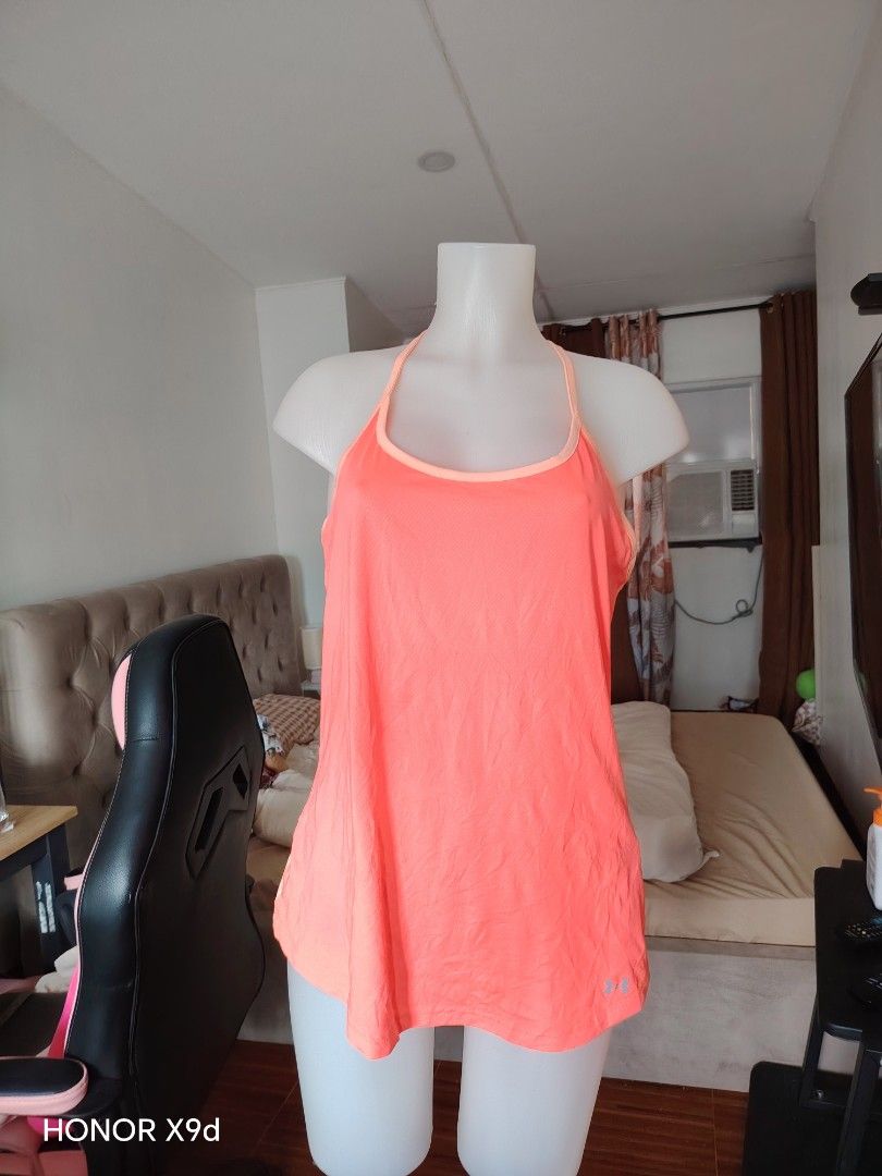 Under Armour HeatGear Workout Tank Top (Category: Sleeveless) located in Mabalacat. Submitted by Jackikay.PreLoved (Listing ID 1469848558, Image 1). Description: Bright peach Under Armour athletic tank top. HeatGear mesh fabric keeps you cool during workouts. Racerback design with vertical Under Armour text on the back spine. Small UA logo on the lower hem. Size LG on the inner tag. Made in the Philippines..