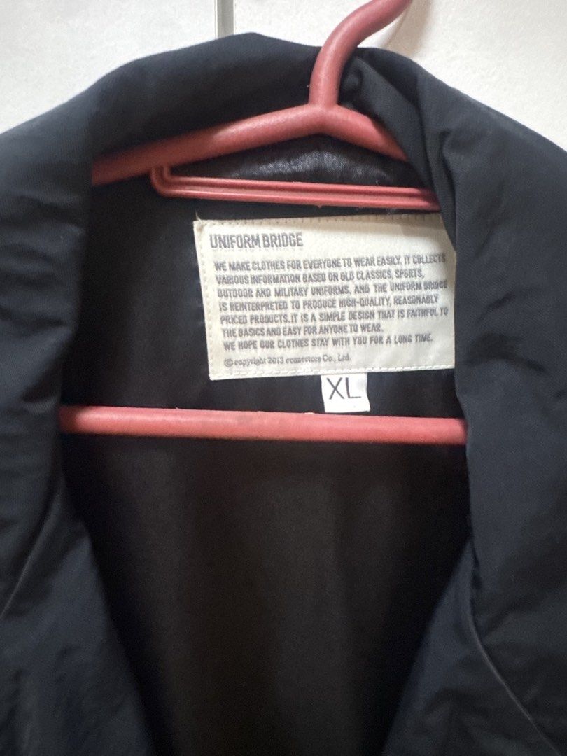 Uniform Bridge Coach Jacket (Category: Coats, Jackets and Outerwear) located in Manila. Submitted by quintessesommerset (Listing ID 1469933675, Image 3). Description: - Brand: Uniform Bridge 23x27 - Style: Coach jacket - Color: Black - Size: XL - Details: Big white letter patch on chest, snap button closure, side pockets, striped ribbed cuffs and hem - Vibe: Classic streetwear layering piece - Condition: Excellent / Ready to wear - Shipping or me