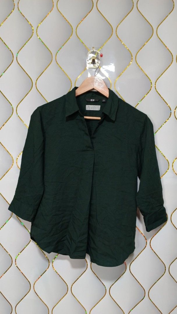 Uniqlo Dark Green Blouse (Category: Shirts) located in Manila. Submitted by zariyah.1986 (Listing ID 1469857333, Image 1). Description: - Brand: Uniqlo - Color: Dark Green - Size: Small (S) - Design: Collar neck with 3/4 sleeves - Material: Lightweight and smooth fabric - Measurements: Pit to pit ~19", Length ~23" - Condition: Clean and ready to wear - Versatile: Great for casual work days or weekend outings.