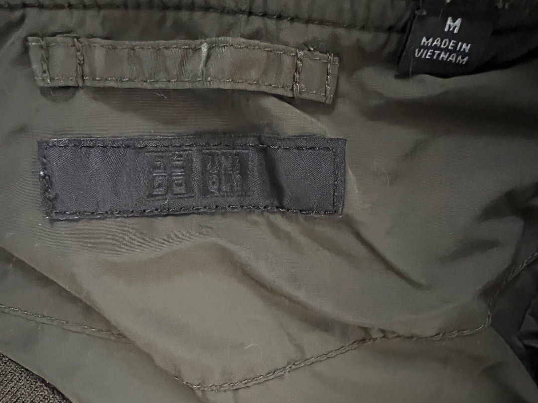 Uniqlo Olive Green Bomber Jacket Size M (Category: Coats, Jackets and Outerwear) located in Muntinlupa City. Submitted by 09leah77 (Listing ID 1469814815, Image 3). Description: - Brand: Uniqlo - Item: Bomber Jacket - Color: Olive Green (Solid Dark Green) - Size: Medium - Origin: Made in Vietnam - Material: Nylon outer shell, polyester lining - Features: Full front zip closure, two side pockets, ribbed collar, cuffs, and hem - Style: Classic casu