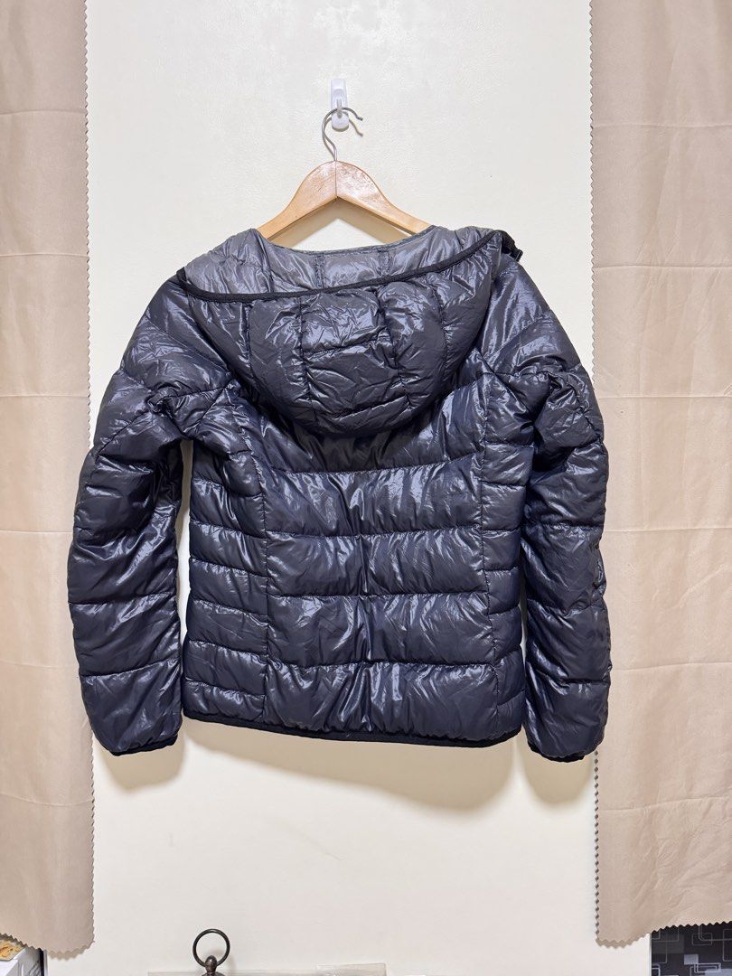 UNIQLO Ultra Light Down Hooded Jacket (Category: Coats, Jackets and Outerwear) located in Manila. Submitted by seayouncey (Listing ID 1469914194, Image 2). Description: - Brand: UNIQLO Ultra Light Down Jacket - Color: Dark Grey - Condition: Brand new with tags attached - Features: Full zip front, attached hood, and quilted puffer design - Fit: Regular fit, hip length - Perks: Warm without the bulk, highly lightweight and easy to pack into a bag.