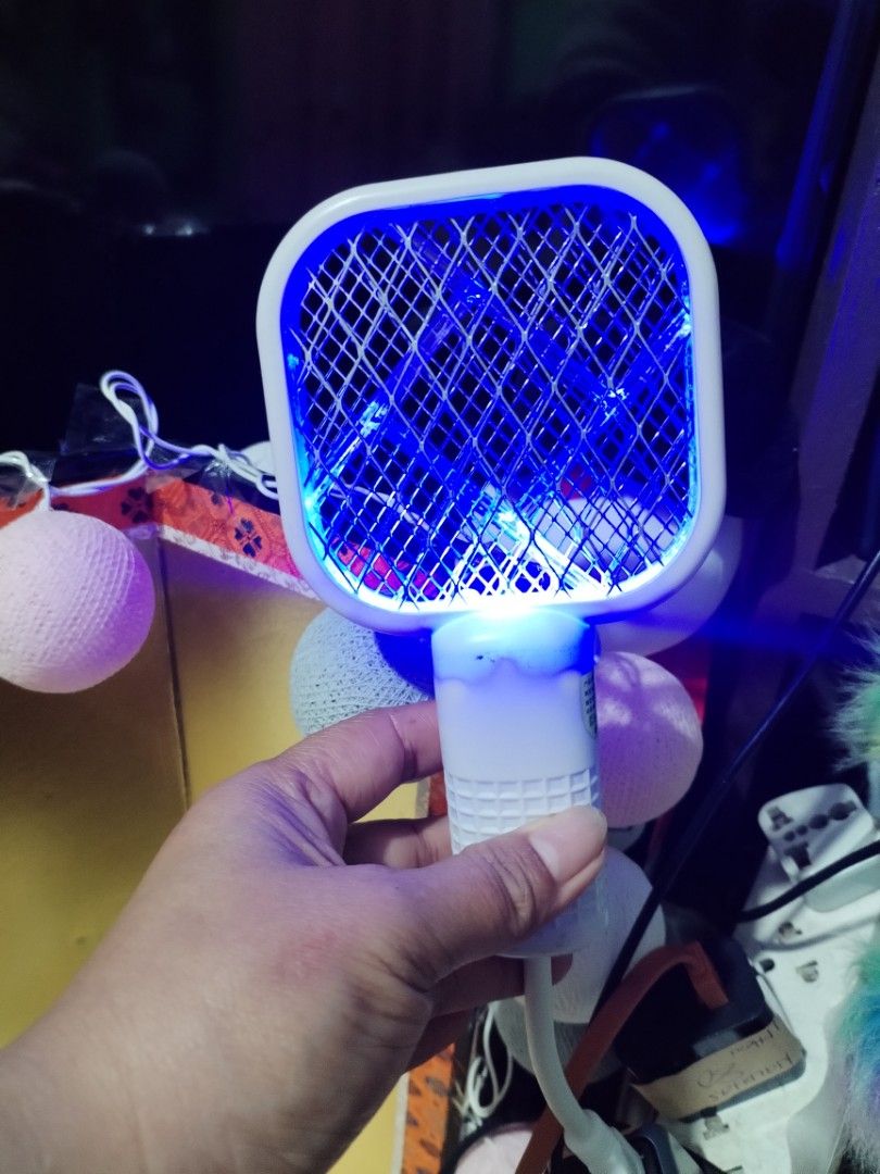 USB Electric Mosquito Swatter Trap Bug Zapper (Category: Insect Repellents) located in La Trinidad. Submitted by malditas (Listing ID 1469919538, Image 3). Description: - 2-in-1 Design: Works as a manual swatter or an automatic UV light bug trap - USB Powered: Conveniently plugs into standard USB ports, power banks, or adapters - Effective Night Use: Bright blue UV light attracts and catches mosquitoes in the dark - Compact & Portable: Easy to pa