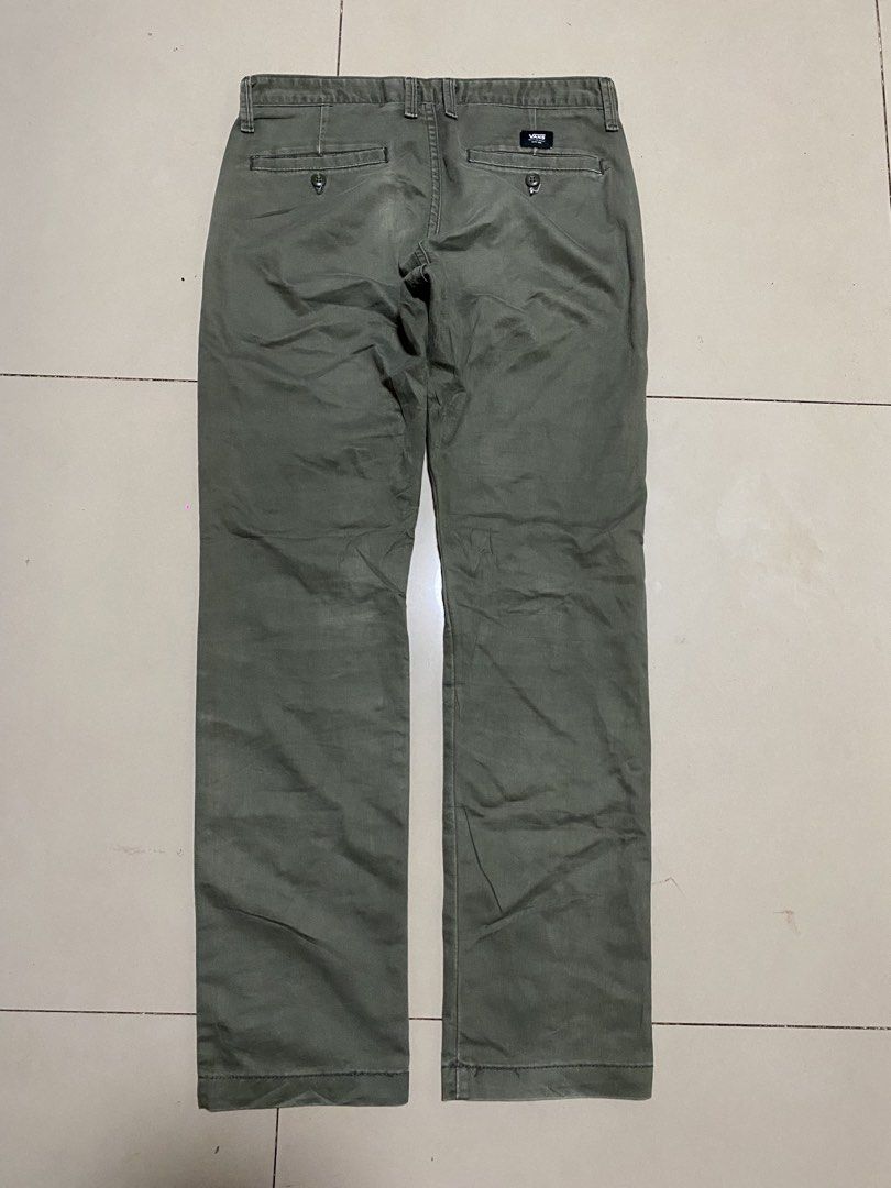 Vans Olive Green Chino Pants Size 30 (Category: Chinos) located in Binalbagan. Submitted by southsidethrift22 (Listing ID 1469891649, Image 3). Description: - Brand: Vans - Style: Olive green chinos, classic straight fit - Size: 30 - Details: Back welt pockets, button closure, branded Vans woven label - Origin: Made in Nicaragua with US fabric - Condition: Clean and ready to wear, featuring minor wear around the seams and a loose thread near the 