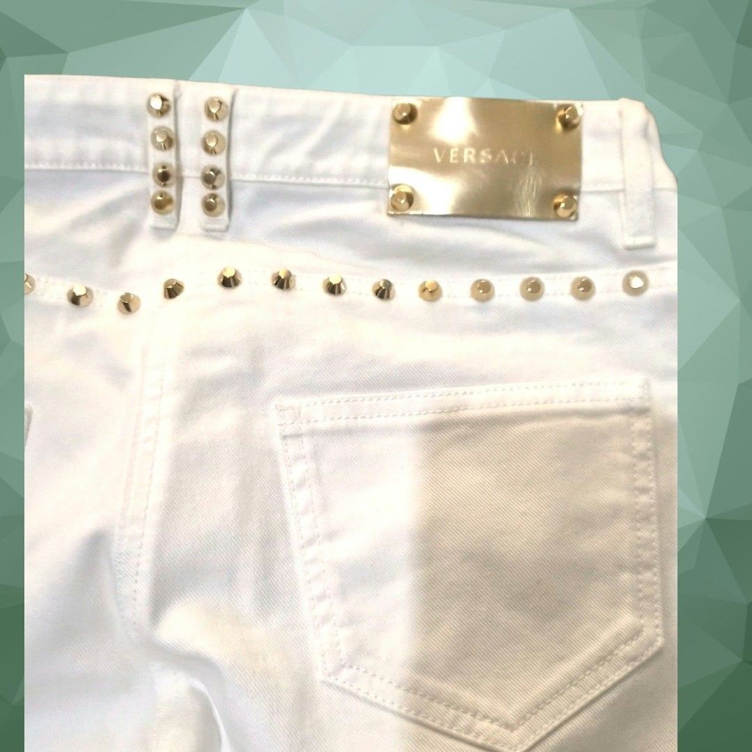 Versace White Studded Denim Jeans (Category: Jeans) located in Paranaque City. Submitted by calm_youngstore7 (Listing ID 1469873305, Image 3). Description: ON SALE! VERSACE STUDDED JEANS 70% OFF RETAIL! LAST PIECE SALE! - Brand: Versace - Color: White denim - Hardware: Gold-tone studs on side seams and pockets - Details: Gold metal logo patch on back waistband - Closure: Branded button closure - Style: Classic five-pocket design - Condition: Exce