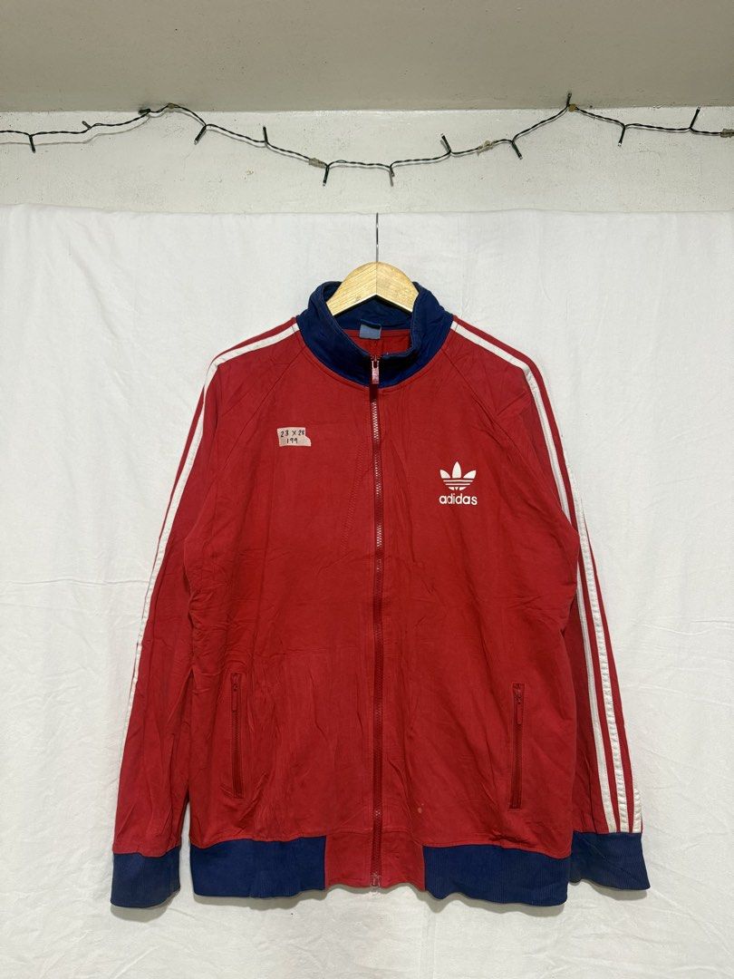Vintage Adidas Red Blue Track Jacket (Category: Coats, Jackets and Outerwear) located in Quezon City. Submitted by dapanaaaay (Listing ID 1469926124, Image 1). Description: - Brand: Adidas - Color: Red with blue collar/hem and white accents - Design: Classic white trefoil logo and 3 stripes down both sleeves - Features: Full zip front, 2 zippered pockets, ribbed cuffs and bottom band - Size: 23 by 28 (based on attached tag) - Condition: Excellent