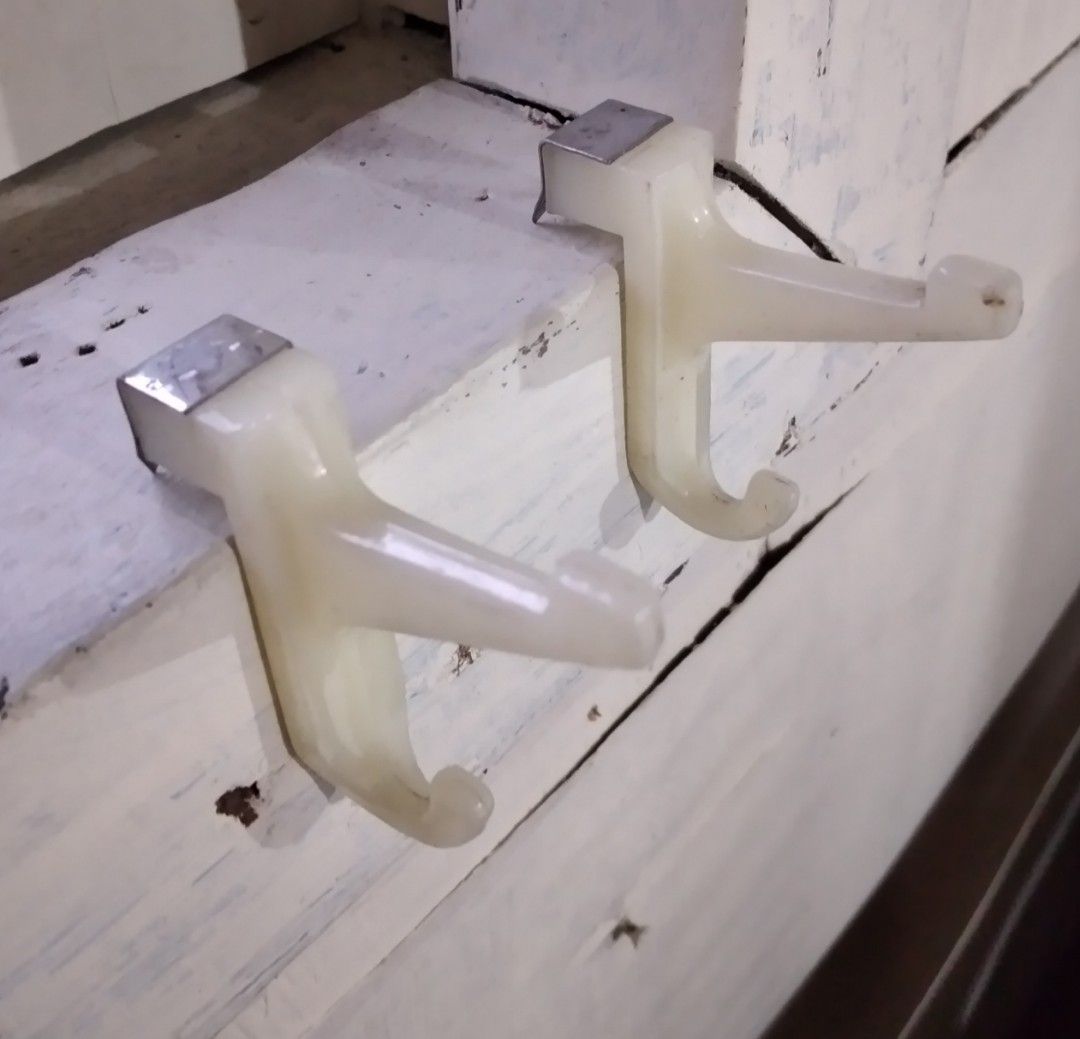 Vintage Adjustable Portable Removable White Plastic Cabinet Hooks (Category: Hooks & Hangers) located in Baguio. Submitted by tipiditis (Listing ID 1469860467, Image 2). Description: - Set of 2 off-white plastic hooks with durable metal mounting brackets - Secure grip on cabinet edges or door frames - Sturdy dual-hook design for extra hanging space - Ideal for towels, aprons, pot holders, and lightweight kitchen tools - Clean condition with minim