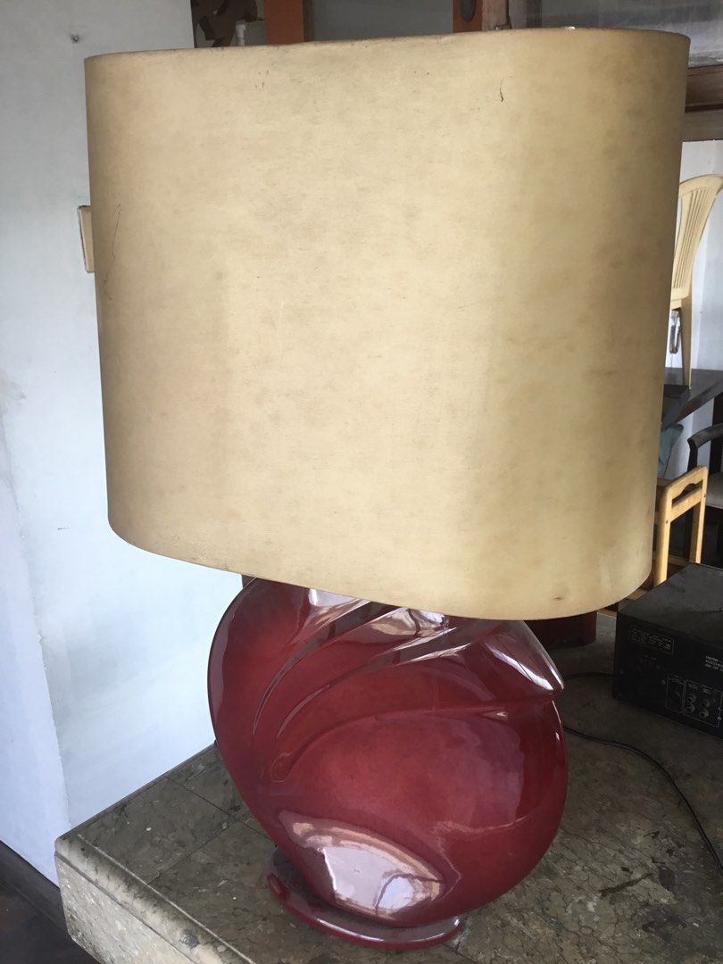 Vintage Ceramic Table Lamp with Beige Shade (Category: Lighting) located in Manila. Submitted by roberto.enriquez (Listing ID 1469816907, Image 1). Description: - Unique deep red ceramic base with flowing carved details - Large rectangular beige lampshade featuring visible side stitching - Heavy statement piece ideal for bedside tables or living room sideboards - Fully working electrical cord with standard plug attached Height 30 inches .