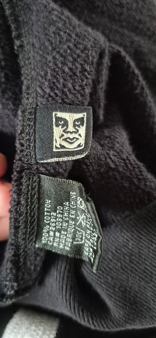Vintage OBEY Script / Cursive Logo Full-Zip Hoodie (Category: Coats, Jackets and Outerwear) located in Taguig. Submitted by regimennn (Listing ID 1469846844, Image 3). Description: - Brand: Obey Vintager Script Skating Oversized Hoodie - Style: Zip-up hoodie with drawstring - Color: Black with large white script logo across the chest - Size: XL - Material: 100% cotton - Hardware: Durable YKK full metal zip.