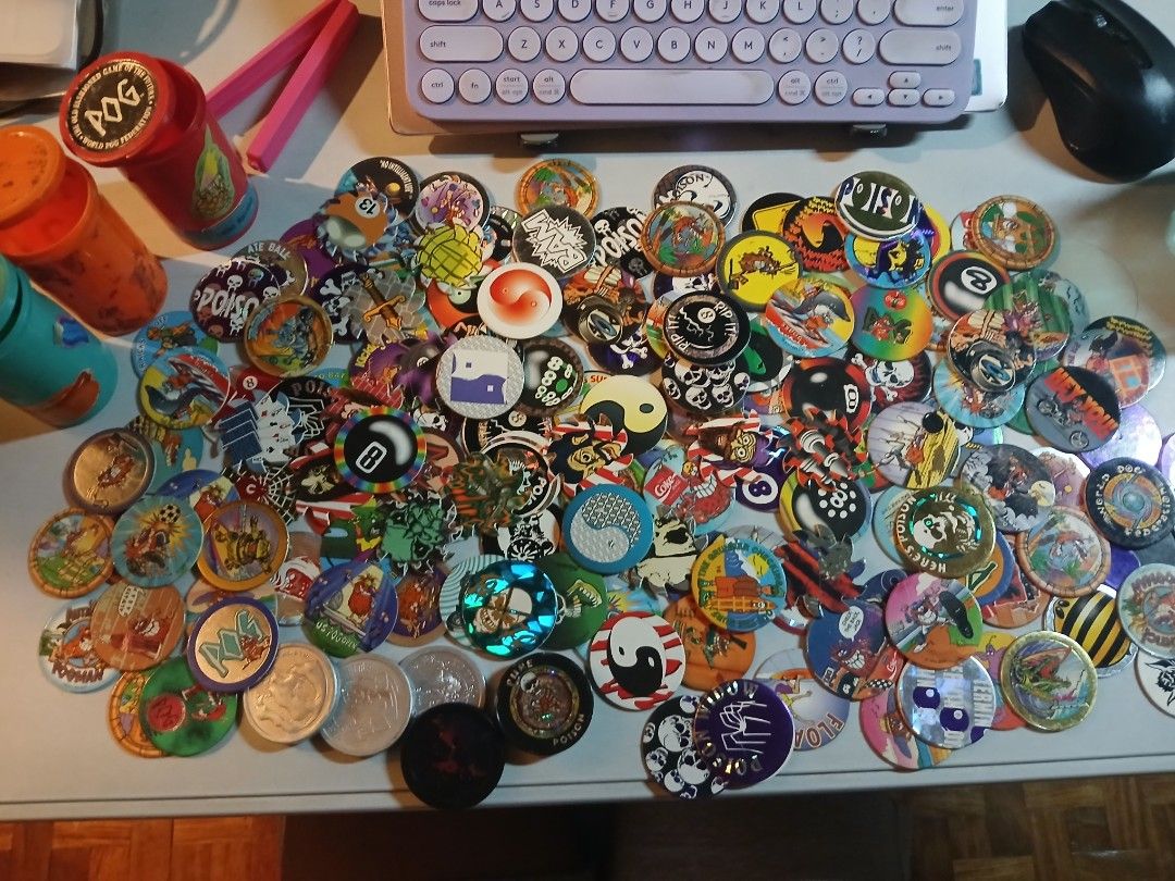 Vintage Pog collection (Category: Vintage Collectibles) located in Quezon City. Submitted by lorenzomarcalain (Listing ID 1469855090, Image 1). Description: - Massive collection of vintage 90s POGs, and metal slammers - Includes 3 plastic storage tubes (red, orange, and blue) - Features cool graphics, skulls, cartoons, and 8-ball designs - Great throwback lot for collectors and nostalgia seekers - Relive the classic 90s playground game!.
