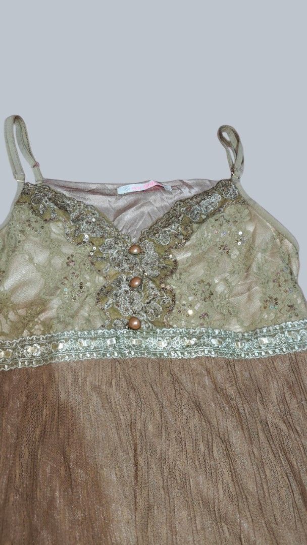 Vintage style lace and sequin cami top (Category: Sleeveless) located in San Francisco. Submitted by Intaw20 (Listing ID 1469797958, Image 2). Description: - Green lace cami top with sparkly sequin neckline - Contrast brown pleated bottom with pretty embroidered trim - Thin adjustable shoulder straps for a custom fit - Three decorative buttons down the front center - Smooth inner lining for comfort - Perfect layering piece for casual or dressed-u