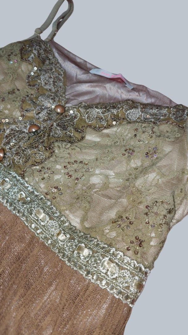 Vintage style lace and sequin cami top (Category: Sleeveless) located in San Francisco. Submitted by Intaw20 (Listing ID 1469797958, Image 3). Description: - Green lace cami top with sparkly sequin neckline - Contrast brown pleated bottom with pretty embroidered trim - Thin adjustable shoulder straps for a custom fit - Three decorative buttons down the front center - Smooth inner lining for comfort - Perfect layering piece for casual or dressed-u
