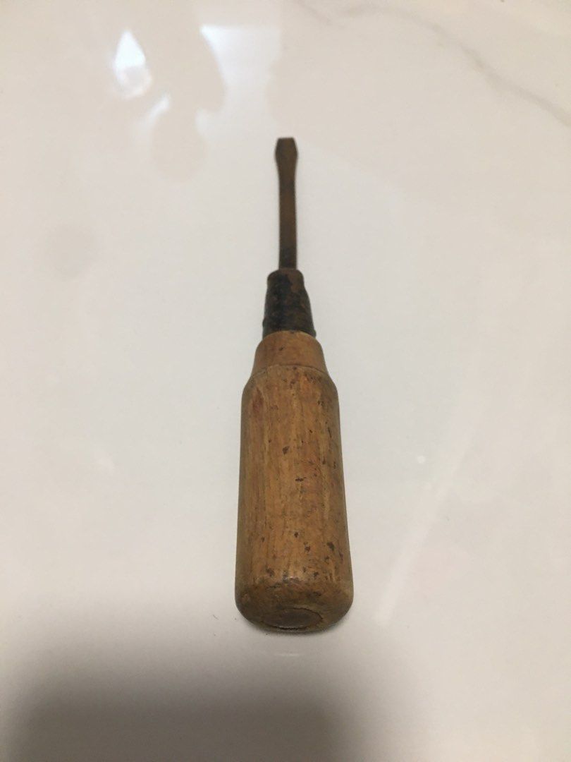 Vintage wooden handle flathead screwdriver antique tool (Category: Vintage Collectibles) located in Pasay City. Submitted by gilbertso62551 (Listing ID 1469827721, Image 1). Description: - Vintage flathead screwdriver with solid, heavy-duty construction - Sturdy wooden handle with natural weathering and age marks - Metal shank featuring authentic rust spots for a rustic look - Ideal for antique tool collectors, rustic displays, or restoration pro
