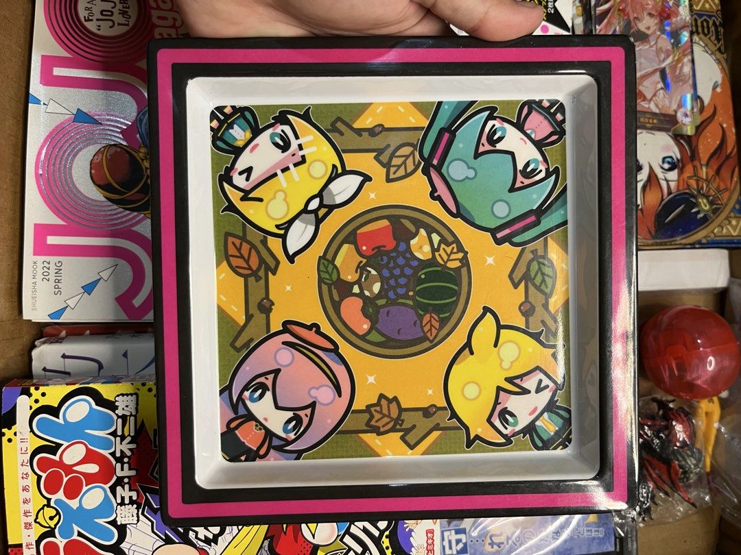Vocaloid Crypton Future Media Square Plastic Tray (Category: Character Goods) located in Gapan. Submitted by lunashop14 (Listing ID 1469798872, Image 1). Description: - Authentic Vocaloid decorative tray featuring Miku, Rin, Len, and Luka - Features a vibrant autumn leaves and fruit illustration surrounding the central bowl - Stylish white base framed with a thick black and pink border - High-quality, solid build with a smooth glossy surface fini