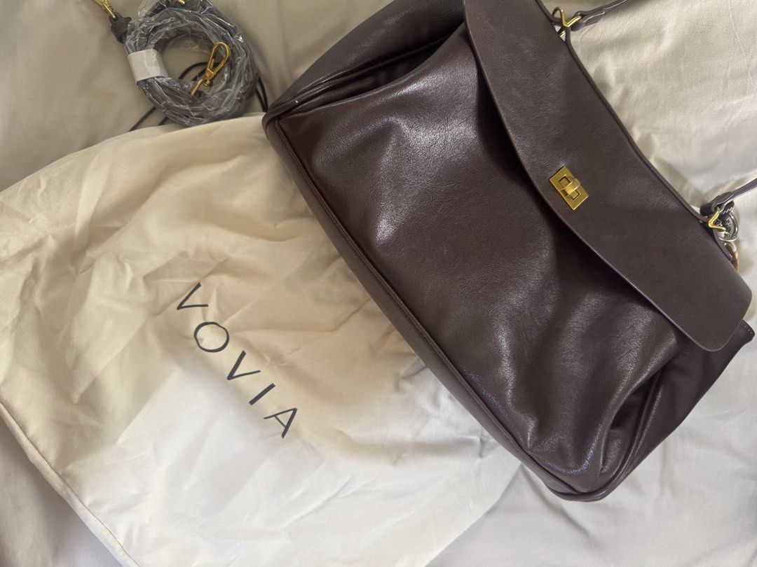 Vovia Brown Leather Shoulder Bag (Category: Shoulder Bags) located in Makati City. Submitted by ckrealty (Listing ID 1469801988, Image 1). Description: Bought originally 6300 online Brand: Vovia - Color/Material: Brown leather - Design: Structured flap with gold turn-lock closure - Interior: Spacious, fits daily essentials easily - Condition: Minor scuffs on corners and hardware - Inclusions: Matching dust bag and extra strap (still wrapped in pl