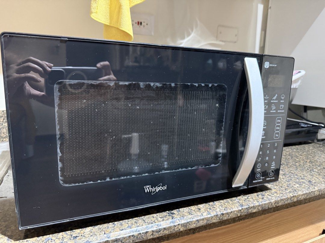 Whirlpool Black Microwave Oven with Digital Controls (Category: Ovens & Toasters) located in Mandaluyong City. Submitted by karuye_ (Listing ID 1469803220, Image 1). Description: - Brand: Whirlpool - Color: Black with silver handle and digital control panel - Condition: Fully working and tested, standard white interior with minor heat discoloration (cleans up easily) - Features: Digital controls, glass turntable plate - Inclusions: Clear plastic 