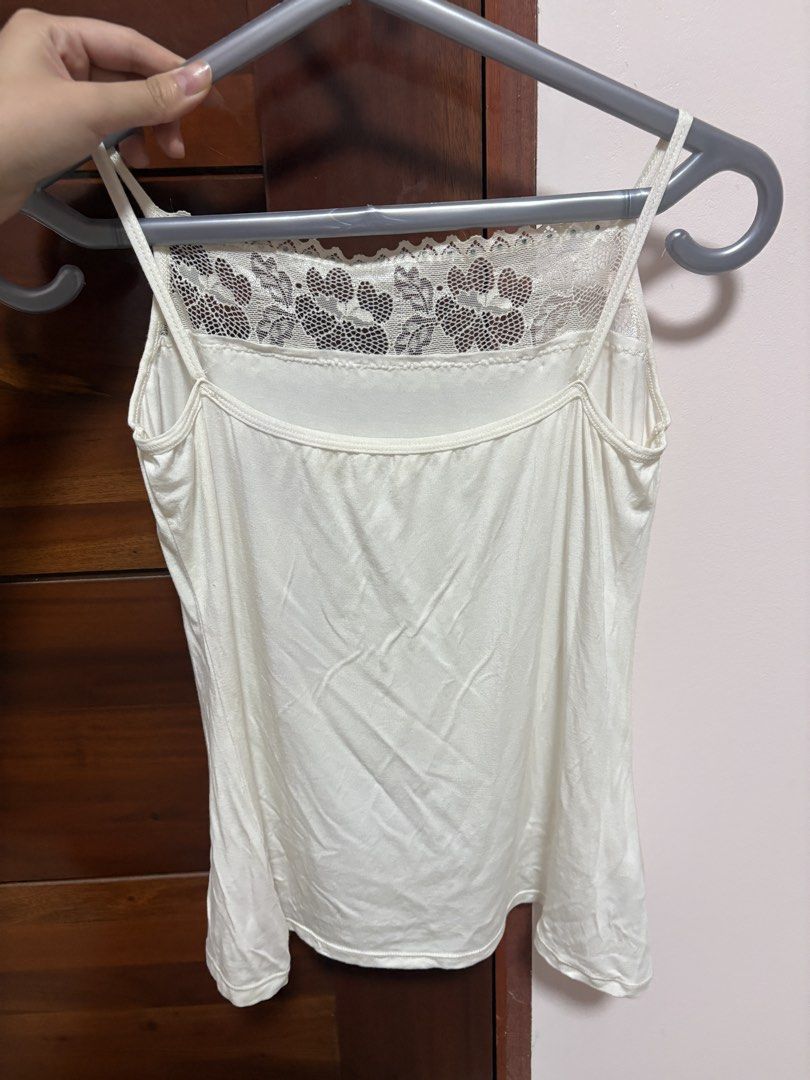 White Floral Lace Tank Top (Category: Sleeveless) located in Quezon City. Submitted by jjccly (Listing ID 1469913983, Image 2). Description: pre-loved pls manage ur expectations size xs-s flaw: small pink discoloration, missing gemstone no ww/addtl pic reqs.