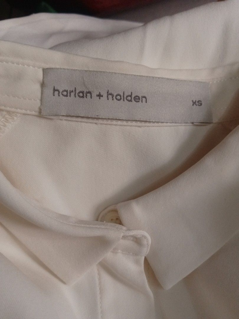 White sleeveless button-down shirt collared top (Category: Sleeveless) located in Manila. Submitted by charlottej01596 (Listing ID 1469775193, Image 3). Description: - Color: Solid White - Design: Sleeveless with classic collar and clean concealed button placket - Fit: Standard cut, hits around the hip - Fabric: Lightweight and breathable, ideal for warm weather or layering - Versatility: Easy to pair with any pants, skirts, or blazers.