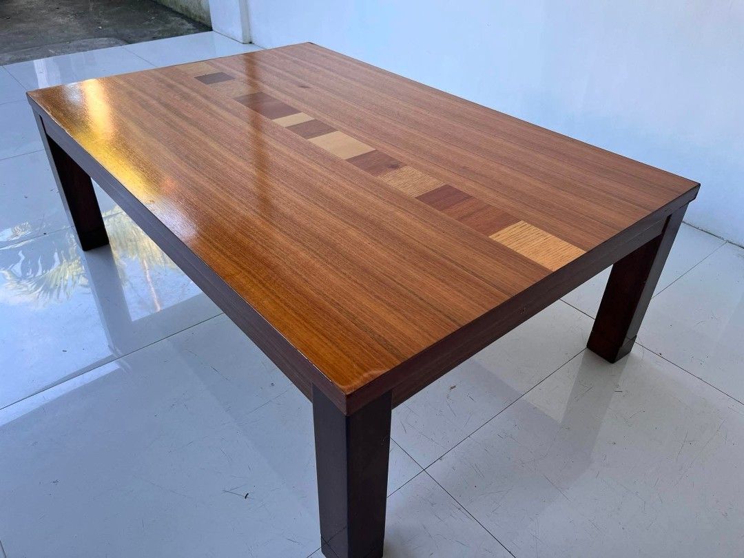 Wooden coffee table with decorative inlay stripe (Category: Tables & Sets) located in Manila. Submitted by roveeeeelen_06 (Listing ID 1469764102, Image 2). Description: - Solid wood construction with a smooth, glossy finish - Eye-catching decorative stripe made of alternating wood tones down the center - Clean rectangular shape with a sturdy four-leg design - Natural wood grain visible throughout - Versatile size, fits nicely in living rooms or l
