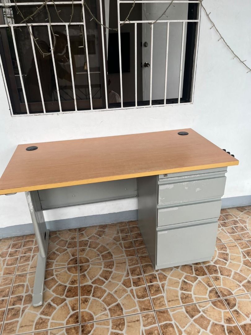 Wooden Office Desk with Drawers (Category: Office Furniture & Fixtures) located in Antipolo. Submitted by simpleboy0 (Listing ID 1469796236, Image 2). Description: FIXED PRICE Condition: Well-used. Pero matibay pa din. Very sturdy, no wobble. Mabigat sya compared sa mga desk sa orange app na mura. Dimensions: 120 x 60 x 74 cm (LxWxH) Aesthetic: 7.5/10 (see flaws below) Top: Wooden grain and laminated Base: Metal frame with attached drawers, powde