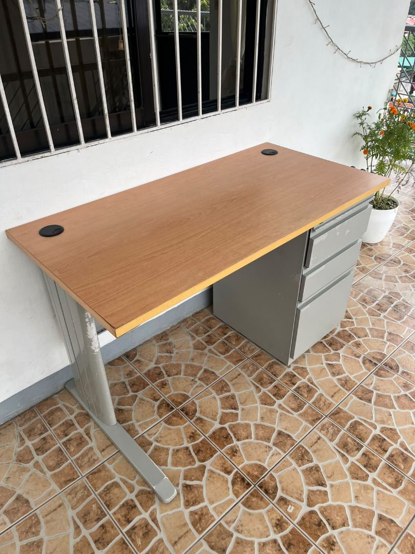 Wooden Office Desk with Drawers (Category: Office Furniture & Fixtures) located in Antipolo. Submitted by simpleboy0 (Listing ID 1469796236, Image 1). Description: FIXED PRICE Condition: Well-used. Pero matibay pa din. Very sturdy, no wobble. Mabigat sya compared sa mga desk sa orange app na mura. Dimensions: 120 x 60 x 74 cm (LxWxH) Aesthetic: 7.5/10 (see flaws below) Top: Wooden grain and laminated Base: Metal frame with attached drawers, powde