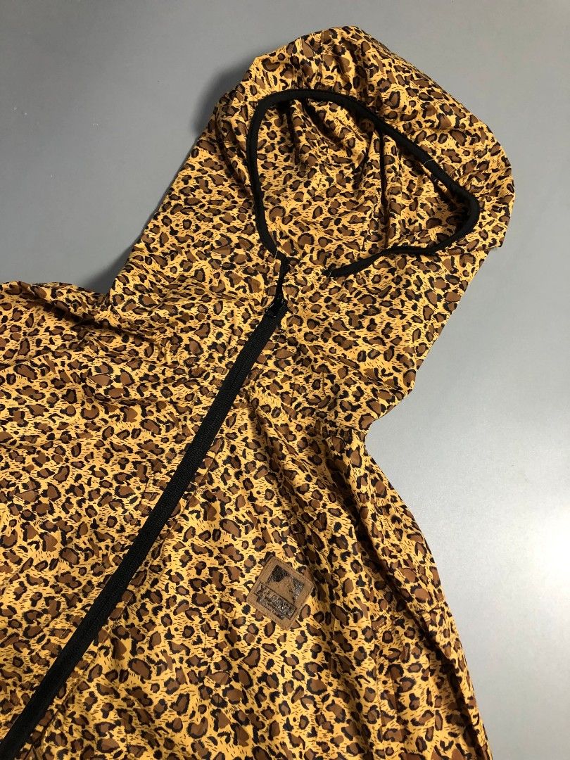 X-Large Leopard Print Zip-Up Windbreaker Jacket (Category: Coats, Jackets and Outerwear) located in Manila. Submitted by j_fnds.dvo (Listing ID 1469878240, Image 2). Description: - Style: Leopard print windbreaker - Features: Full zip front, attached hood, branded leather patch, and hem logo tag - Material: Lightweight, ideal for windy weather - Sizing: Marked Size M inside, but fits X-Large - Condition: Clean inside and out, flawless.