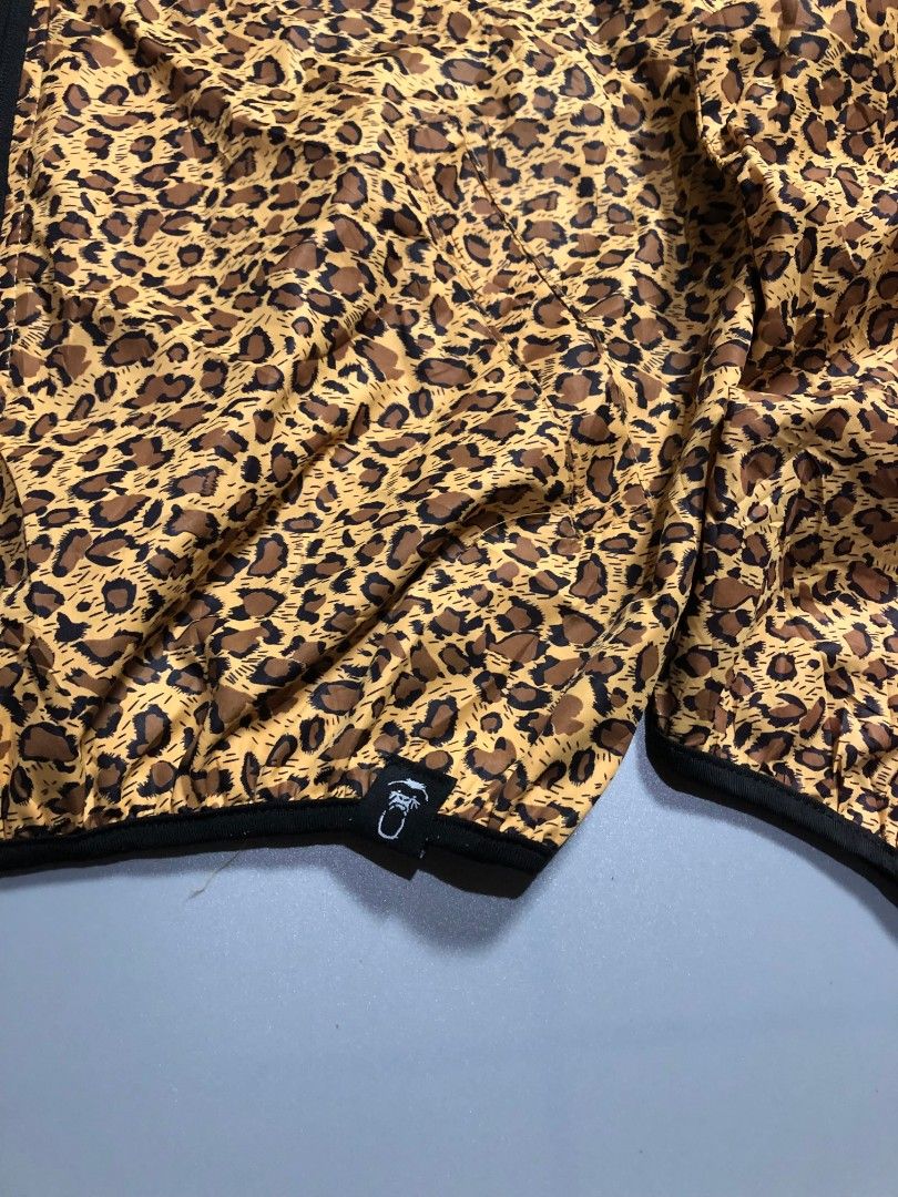 X-Large Leopard Print Zip-Up Windbreaker Jacket (Category: Coats, Jackets and Outerwear) located in Manila. Submitted by j_fnds.dvo (Listing ID 1469878240, Image 3). Description: - Style: Leopard print windbreaker - Features: Full zip front, attached hood, branded leather patch, and hem logo tag - Material: Lightweight, ideal for windy weather - Sizing: Marked Size M inside, but fits X-Large - Condition: Clean inside and out, flawless.