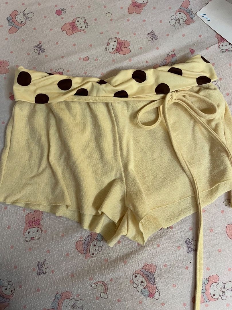 Yellow Polka Dot Fold-Over Lounge Shorts (Category: Shorts) located in Caloocan City. Submitted by zaviscool (Listing ID 1469874058, Image 1). Description: - Color: Light yellow with dark brown polka dots on the waistband - Material: Soft and comfortable fabric - Fit: Adjustable front tie string for a custom fit - Style: Folded waistband detail - Best for: Sleepwear, lounging, or casual days at home - Easy pairing: Matches great with any simple t