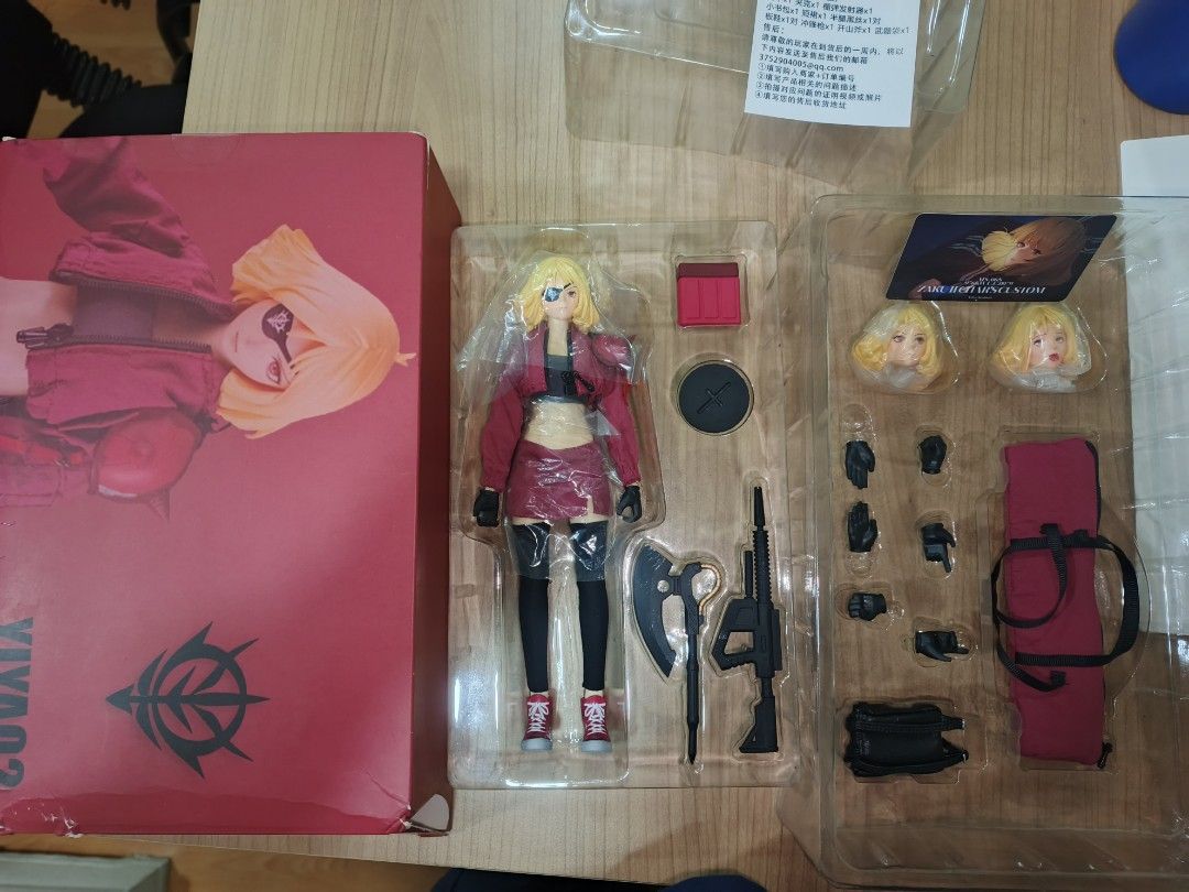 YIYA02 Char Aznable Custom Action Figure (Category: Figurines & Statues) located in Cavite. Submitted by henricoh (Listing ID 1469763601, Image 1). Description: YIYA02 STUDIO zaku girl female action figure, custom Char Aznable style from Gundam. Blonde hair, eyepatch, red jacket, skirt, boots. Includes extra interchangeable face plates, multiple hand gestures, rifle, heat hawk axe, storage box, fabric components, and display stand inside original