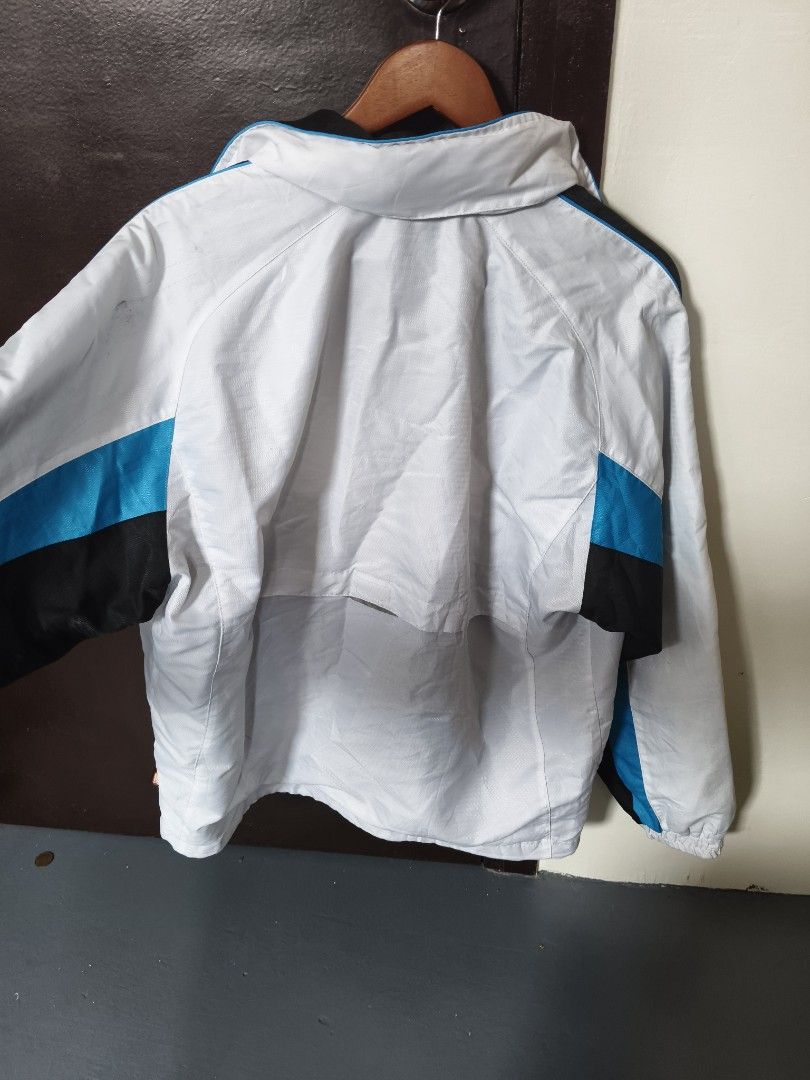 Yonex Heat Capsule Windbreaker Jacket (Category: Coats, Jackets and Outerwear) located in Manila. Submitted by ian.frias_ (Listing ID 1469840105, Image 2). Description: - Brand/Model: Authentic Yonex Windbreaker - Color: White with black and blue color blocking - Size: Large - Technology: Heat Capsule tech for body and solar warmth retention - Features: Hood with adjustable drawstrings, full zippered front, and elasticized cuffs - Details: Embroi