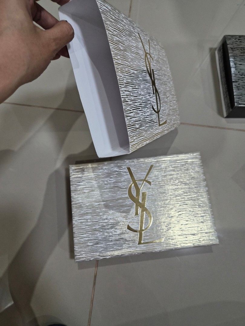 YSL Empty Gift Boxes Packaging (Category: Everything Else Others) located in Paranaque City. Submitted by lovelife.312 (Listing ID 1469797021, Image 2). Description: ***PLEASE READ CAREFULLY*** - Price stated is per piece - 1 White box - 500 php - 1 Black box - 500 php - Authentic YSL empty gift box sets (Original packaging) - Includes 2 distinct designs: White & gold textured set and Black & silver set - Comes complete with matching outer sleeve