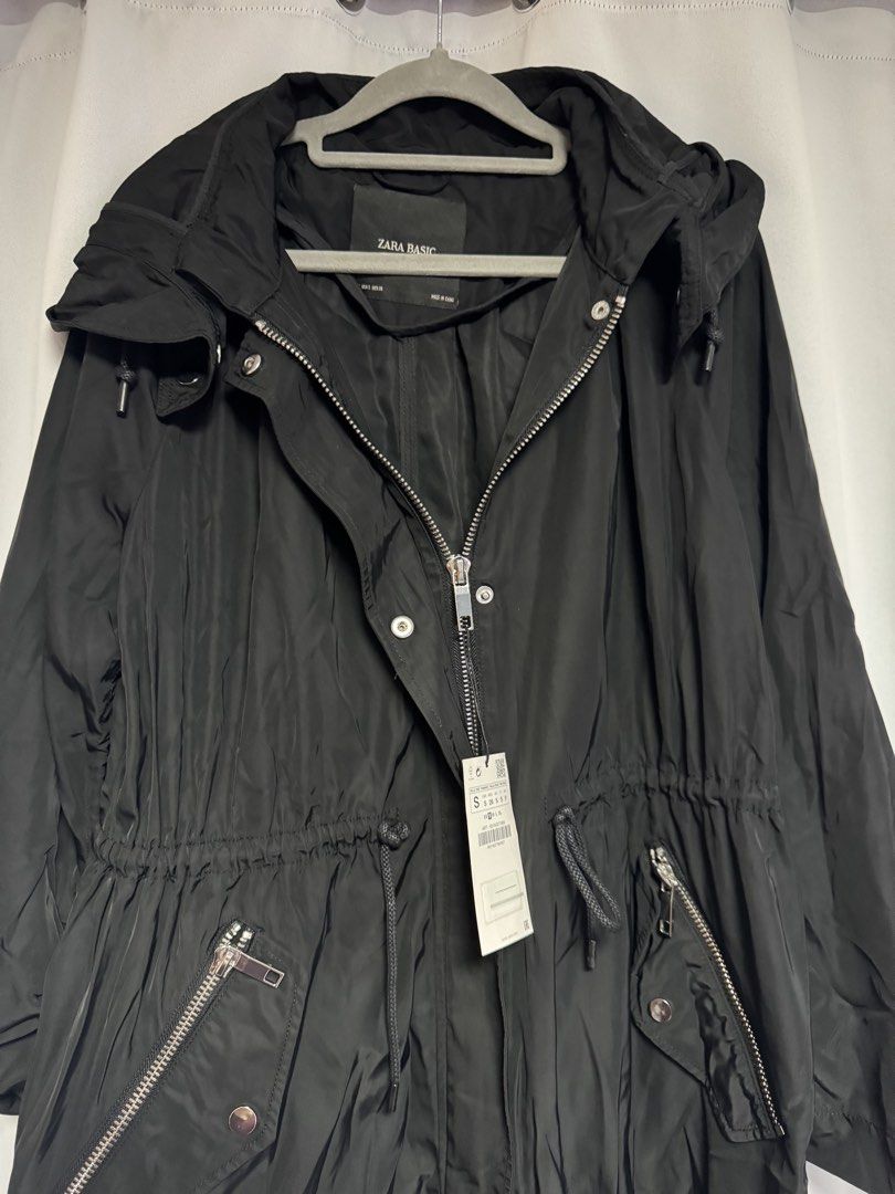 Zara Basic Black Water Repellent Hooded Parka Jacket (Category: Coats, Jackets and Outerwear) located in Calamba. Submitted by cheriiv (Listing ID 1469776286, Image 2). Description: - Brand: Zara Basic - Color: Black - Condition: Brand new with original tags attached - Material: Water-repellent fabric - Features: Attached hood, adjustable drawstring waist for a custom fit, front zipper pockets - Closure: Full front zipper with snap button storm f