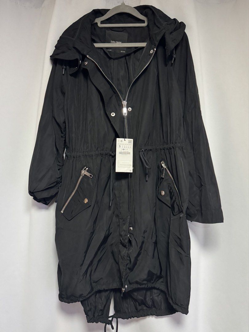 Zara Basic Black Water Repellent Hooded Parka Jacket (Category: Coats, Jackets and Outerwear) located in Calamba. Submitted by cheriiv (Listing ID 1469776286, Image 1). Description: - Brand: Zara Basic - Color: Black - Condition: Brand new with original tags attached - Material: Water-repellent fabric - Features: Attached hood, adjustable drawstring waist for a custom fit, front zipper pockets - Closure: Full front zipper with snap button storm f