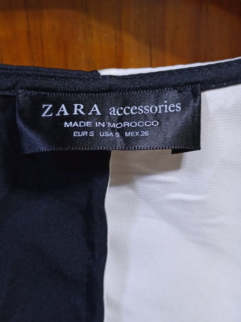 Zara Black and White Split Bodysuit (Category: Sleeveless) located in Baguio. Submitted by cleverhorse_3041f6 (Listing ID 1469860731, Image 3). Description: - Brand: Zara - Style: Split black and white design bodysuit - Neckline: Plunging V-neck - Sleeves: Long sleeves - Closure: Bottom with 3 snap buttons - Size: S - Material: 95% polyester, 5% elastane (secondary fabric) - Origin: Made in Morocco - Condition: Excellent.