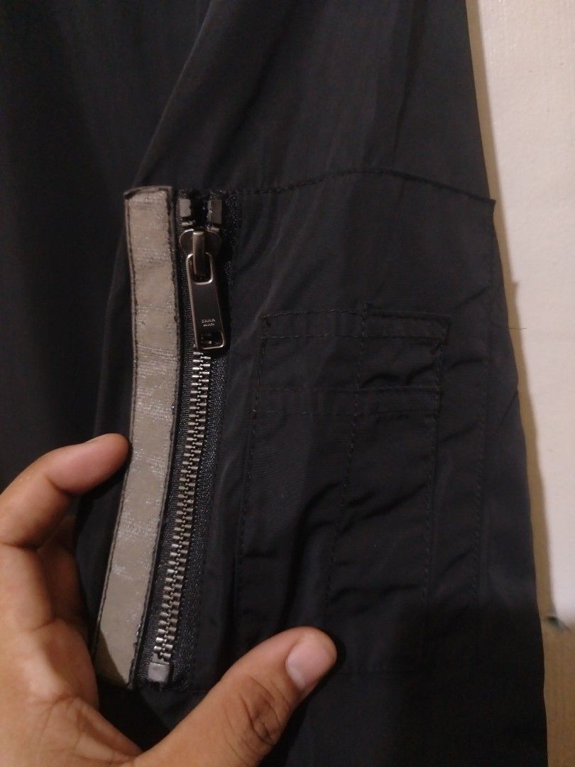 Zara Black Bomber Jacket (Category: Coats, Jackets and Outerwear) located in Rizal. Submitted by gmpastoffi75031 (Listing ID 1469800402, Image 3). Description: - Brand: Zara - dimes 22.5x26 - Color: Black - Size: M - Closure: Front zip - Details: Ribbed collar and cuffs, mesh lining - Pockets: Two side pockets with snap buttons, sleeve utility pocket with zipper - Origin: Made in China.