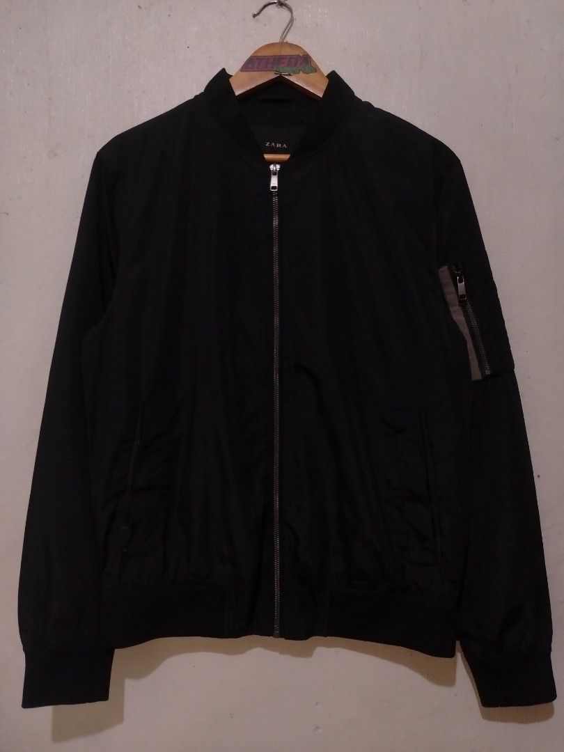 Zara Black Bomber Jacket (Category: Coats, Jackets and Outerwear) located in Rizal. Submitted by gmpastoffi75031 (Listing ID 1469800402, Image 1). Description: - Brand: Zara - dimes 22.5x26 - Color: Black - Size: M - Closure: Front zip - Details: Ribbed collar and cuffs, mesh lining - Pockets: Two side pockets with snap buttons, sleeve utility pocket with zipper - Origin: Made in China.
