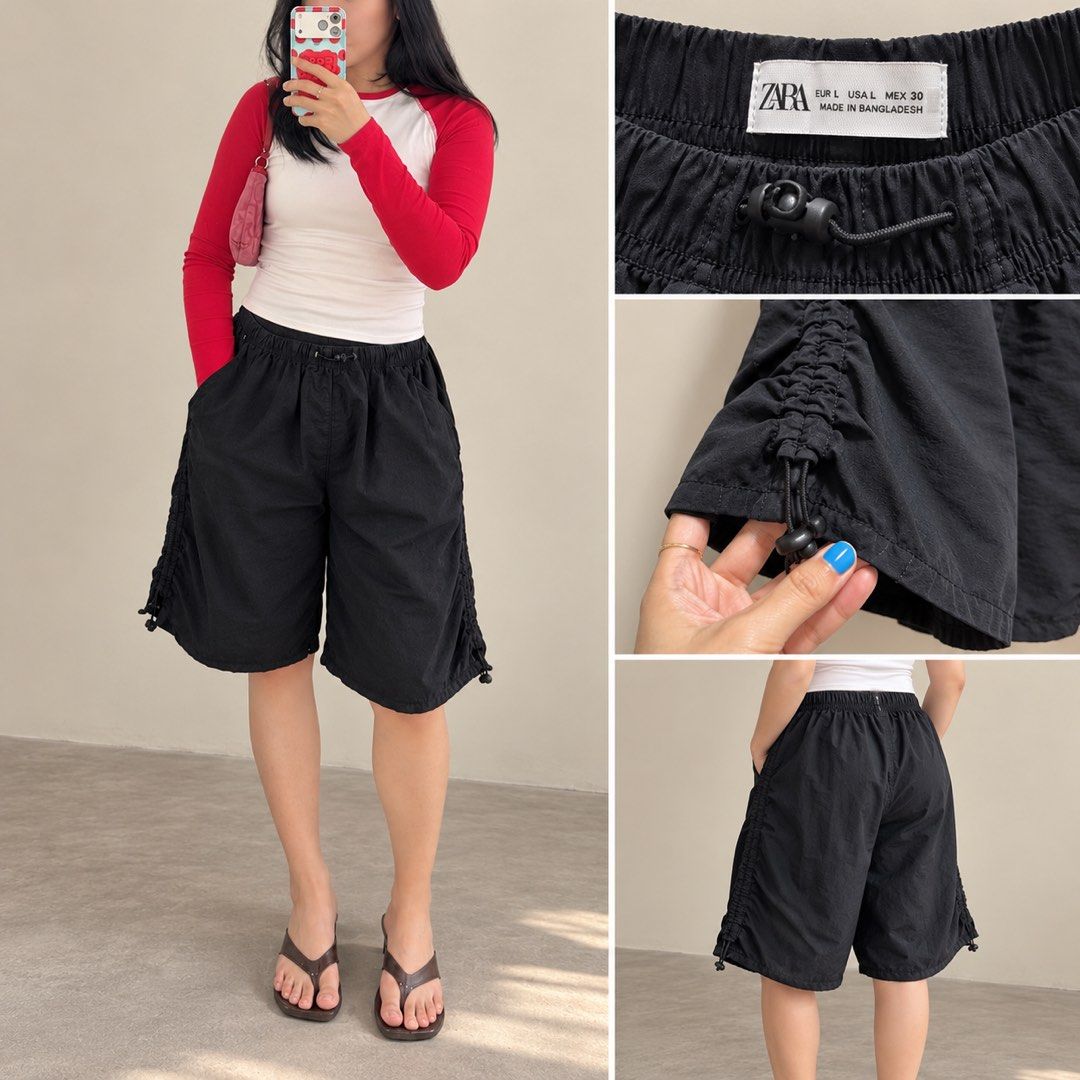ZARA Black Drawstring Parachute Shorts (Category: Shorts) located in Davao. Submitted by 2ndbase.dvo.ii (Listing ID 1469928689, Image 1). Description: - Brand: ZARA - Color: Black - Size: L (EUR L, USA L, MEX 30) - Material: Lightweight and breathable - Fit: Relaxed, knee-length cut - Waistband: Elastic with adjustable drawstring toggle - Features: Adjustable cinched drawstrings on sides for leg opening, deep side pockets - Condition: Clean insid