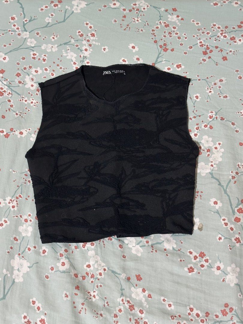 Zara Black Textured Sleeveless Crop Top (Category: Sleeveless) located in Mandaluyong City. Submitted by gelatinxx (Listing ID 1469911491, Image 2). Description: - Brand: Zara - Size: S (tag on collar) but can fit XS frames - Color: Black - Fit: Cropped sleeveless top - Details: Textured pattern throughout, crew neckline, raw hem finish, and backless detail - Material: Lightweight fabric, made in Turkey - Styling: Easy to pair with high-waisted j