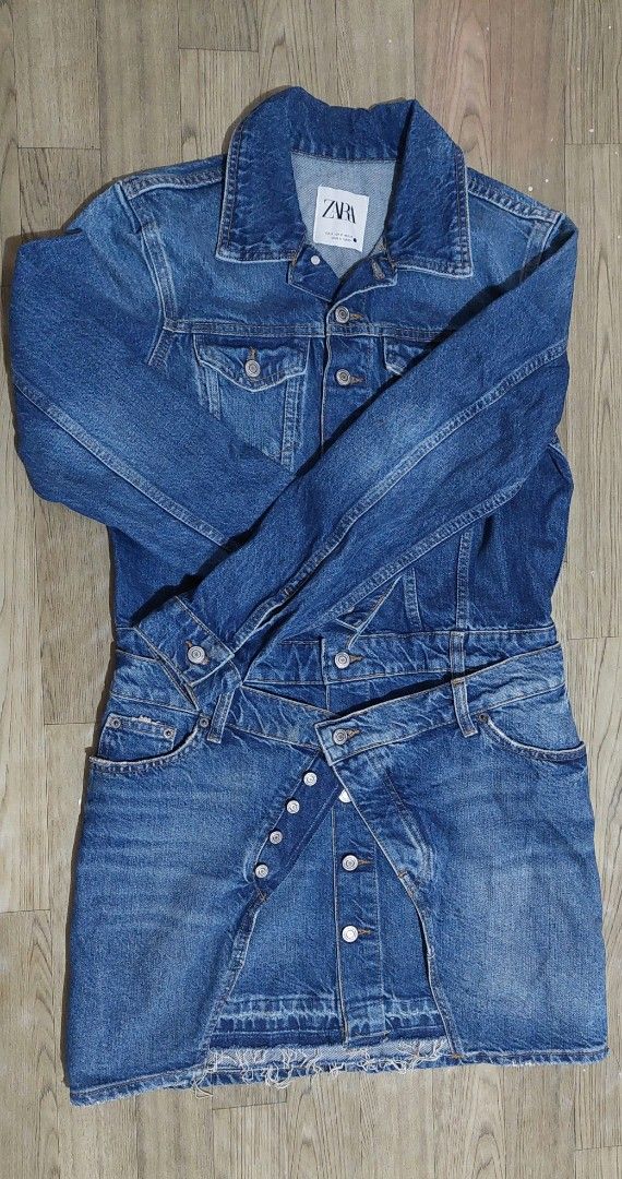 Zara Denim Dress Size S (Category: Dresses) located in Taguig. Submitted by thrifthub.ph (Listing ID 1469788705, Image 2). Description: - Brand: Zara - Size: S - Material/Origin: Made in Turkey - Design: Blue denim mini dress combining a jean jacket top with a skirt bottom - Details: Button-up front with metal buttons, chest pockets, and functional side pockets - Hem: Trendy raw frayed hem - Condition: Excellent.