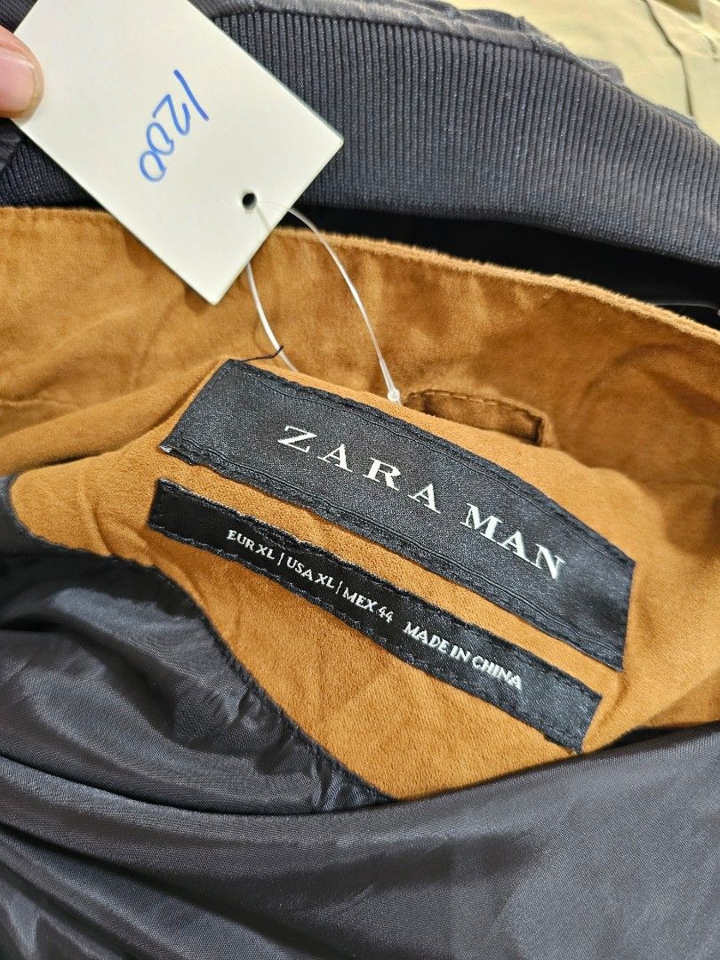 Zara Man Faux Suede Zip-Up Jacket (Category: Coats, Jackets and Outerwear) located in Baguio. Submitted by kayeonlineshop (Listing ID 1469855667, Image 2). Description: features a classic tan or camel faux-suede fabric with a distinctive horizontal stitch line across the chest, a small stand-up/mock collar, side welt pockets, and a full central zipper..