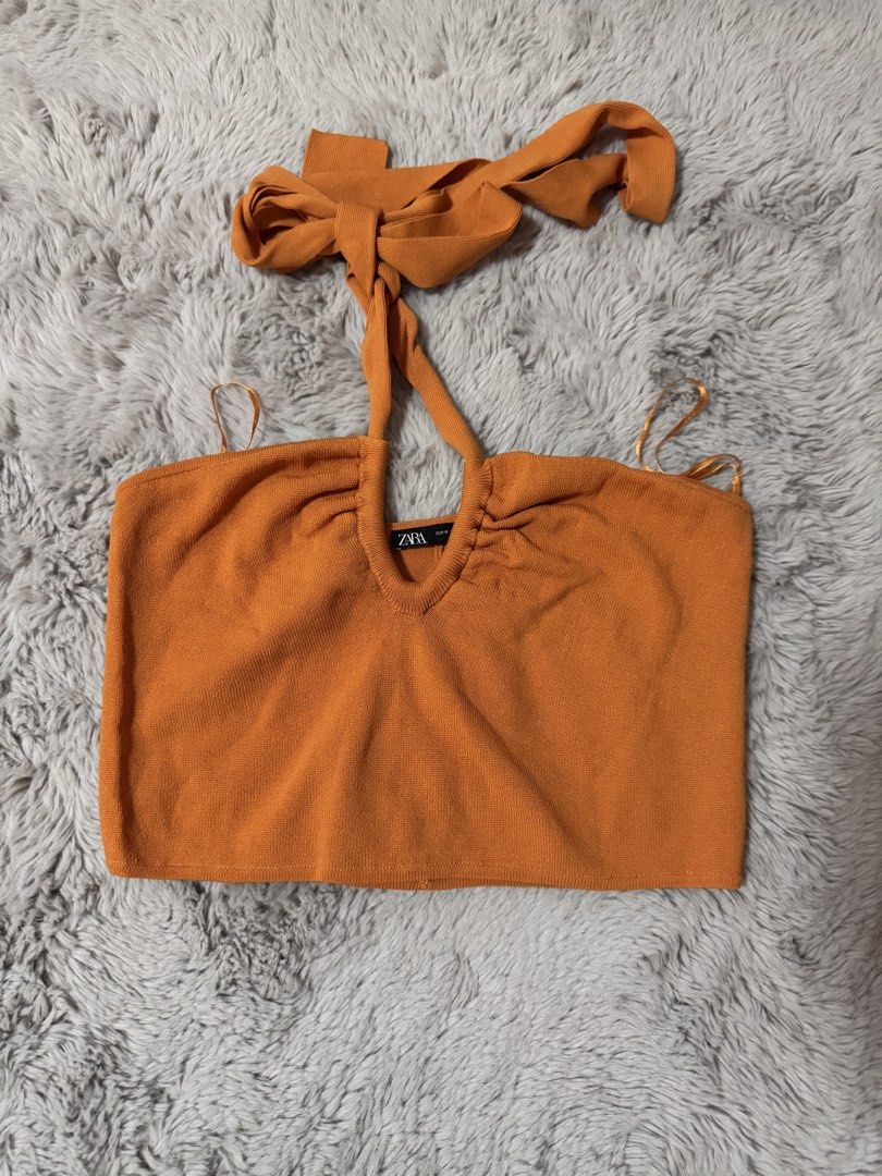 Zara Orange Knit Halter Crop Top (Category: Sleeveless) located in Calamba. Submitted by cheriiv (Listing ID 1469895367, Image 1). Description: - Brand: Zara - Size: M - Color: Bright orange - Style: Halter neck crop top with tie-back straps and ruched neckline - Material: Soft, stretchy knit.