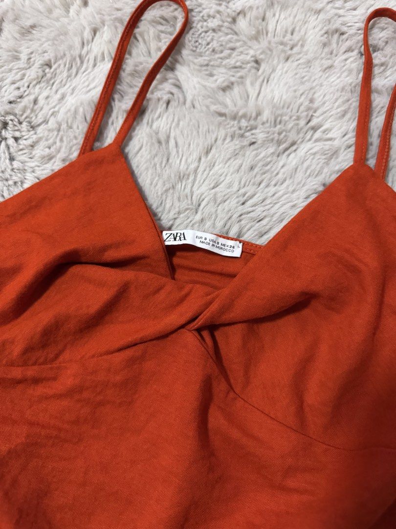 Zara Orange Twist Front Crop Top (Category: Sleeveless) located in Calamba. Submitted by cheriiv (Listing ID 1469886033, Image 2). Description: Very cute!! - Brand: Zara - Color: Rust Orange - Size: Small - Details: Twisted front design, thin spaghetti straps.