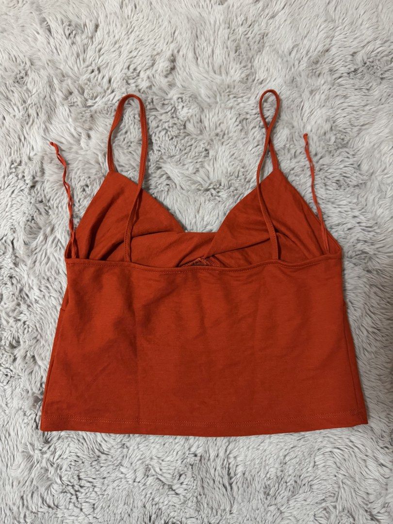 Zara Orange Twist Front Crop Top (Category: Sleeveless) located in Calamba. Submitted by cheriiv (Listing ID 1469886033, Image 3). Description: Very cute!! - Brand: Zara - Color: Rust Orange - Size: Small - Details: Twisted front design, thin spaghetti straps.