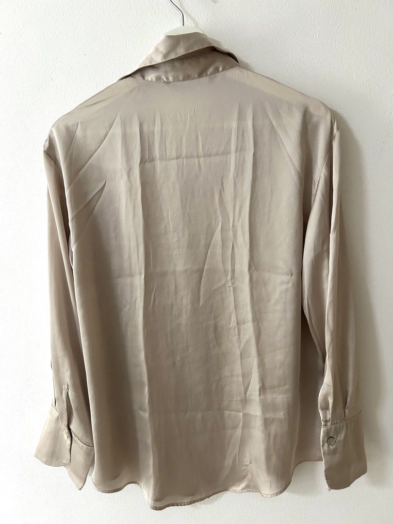 Zara Satin Button-Down Blouse Champagne Size S (Category: Blouses) located in Manila. Submitted by isabelle_1104 (Listing ID 1469943511, Image 3). Description: Condition 8/10. With pinholes in the chest area.