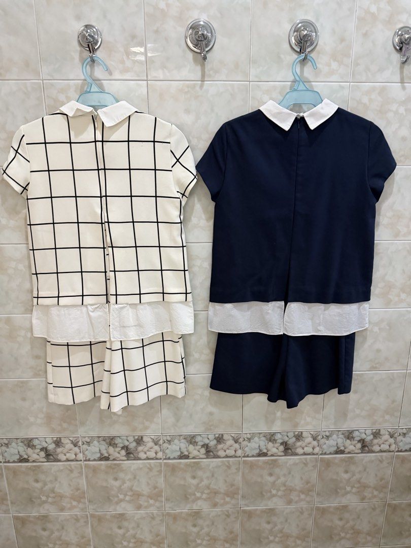 Zara short sleeve romper bundle (Category: Sets or Coordinates) located in Manila. Submitted by jcmph (Listing ID 1469779830, Image 2). Description: - 2-piece set: Short sleeve one piece romper. - Available in 2 color sets: White with black grid pattern & Solid dark blue - Stylish white lapel collar with a trendy white layered hem detail - Easy-wear back zipper closure on the top - High-quality, neat stitching throughout - Perfect for casual outi