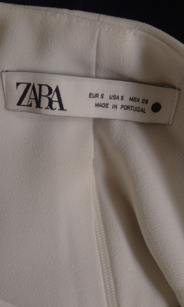 Zara White Cowl Neck Crop Top (Category: Sleeveless) located in Manila. Submitted by charlottej01596 (Listing ID 1469793676, Image 3). Description: - Brand: Zara - Color: Clean White - Style: Sleeveless semi crop top with draped cowl neckline - Details: Structured folds at front and back, wide finished hem - Condition: Excellent, lightweight fabric with clean tag, no stains or pulls.