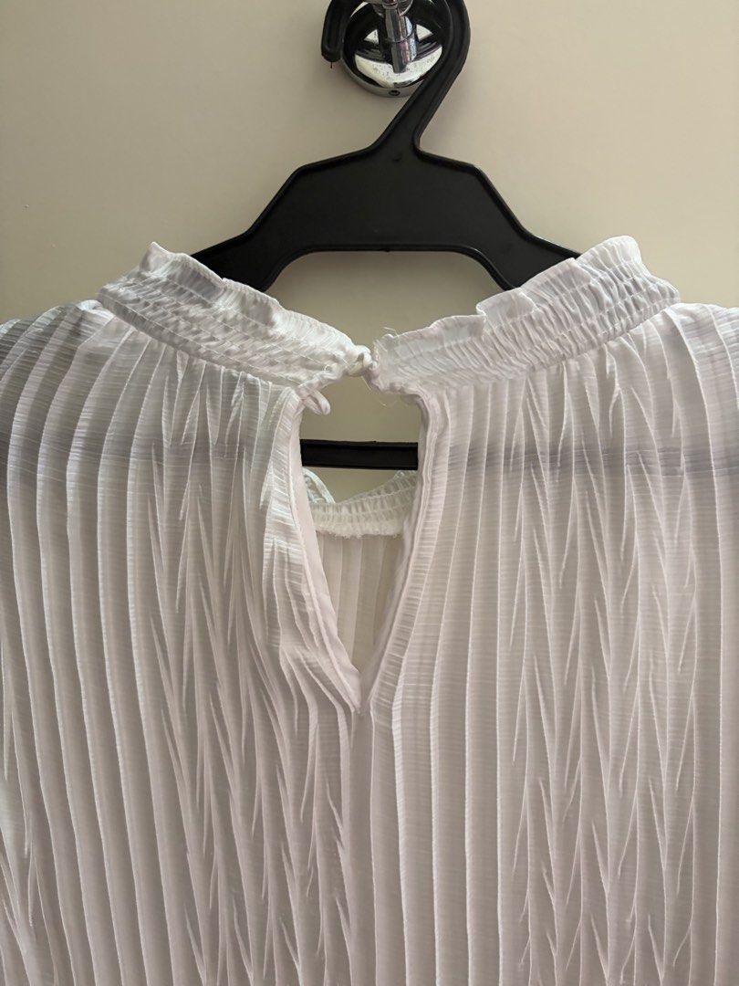 Zara White Pleated Long Sleeve Blouse (Category: Longsleeves) located in Muntinlupa City. Submitted by secondhandlove12345 (Listing ID 1469831361, Image 3). Description: White pleated blouse from Zara. High neckline with ruffled trim and keyhole button closure at the back. Long sleeves with smocked cuffs. Lightweight fabric with all-over vertical pleats and smocked detailing across the midsection. Size EUR XS / USA XS. Great basic top, pairs easi