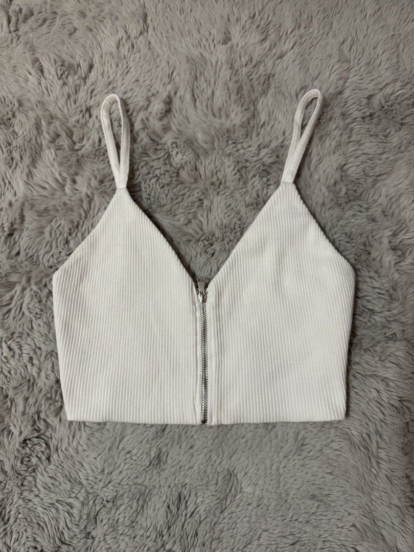 Zara White Ribbed Zip-Front Crop Top (Category: Sleeveless) located in Calamba. Submitted by cheriiv (Listing ID 1469886156, Image 1). Description: - Brand: Zara - Size: S - Color: White - Material: Soft, stretchy ribbed knit - Features: Deep V-neckline, front metal zipper, thin spaghetti straps.
