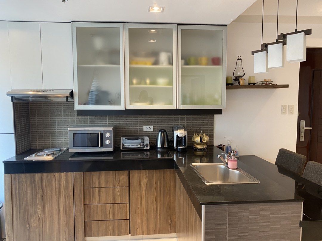 1BR Condo at BGC FOR SALE (Category: Apartments & Condos) located in Mandaluyong City. Submitted by happycrystal.c0df25 (Listing ID 1469984494, Image 3). Description: 1-BR BGC Condominium Unit for sale Corner unit, with Balcony, facing Blue Sapphire Cond. Address: Fort Palm Springs Cond., 30th st cor. 1st Ave, BGC 1BR, 1 T&B, Balcony, Living and Dining open area. Dining is counter-style. Fully furnished. Direct to owner. Direct buyers only.