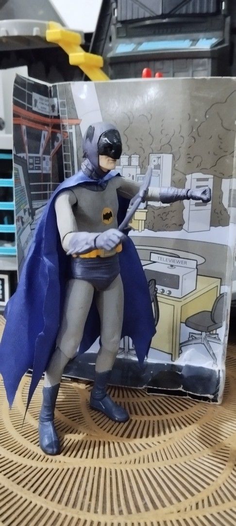 2015 NECA Batman: Adam West (Category: Figurines & Statues) located in Manila. Submitted by ventajetoyz625 (Listing ID 1469967748, Image 2). Description: - Authentic Batman action figure from the classic 1966 TV series line - 7 inches tall - Includes batarang accessory and themed display backdrop - Features articulation points in the arms, legs, and head for dynamic posing - Premium fabric cape for a realistic look - Comes in original packaging b